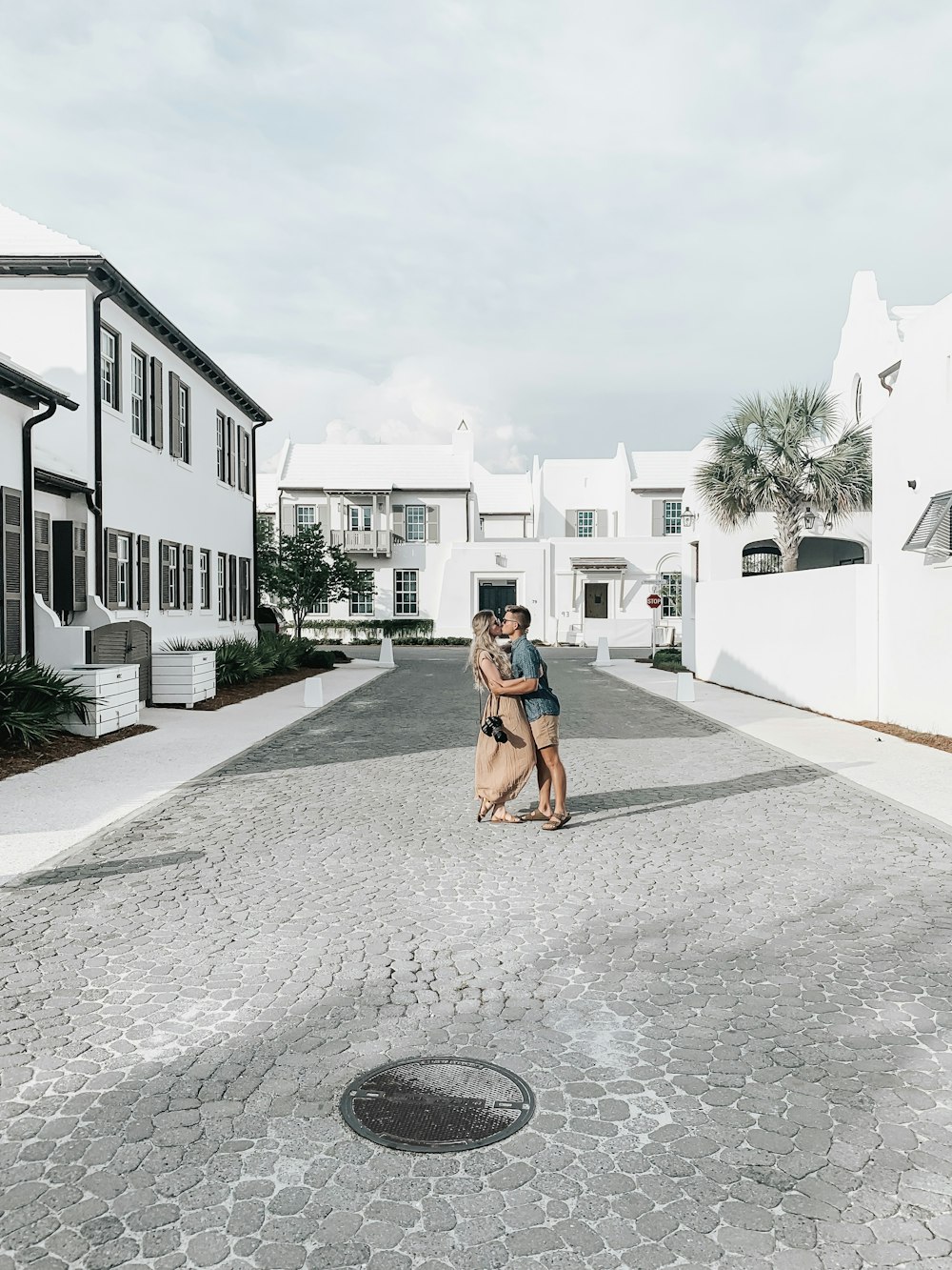 couple kissing at the middle of the street