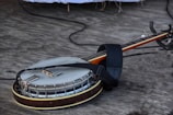 A beautifully worn banjo resting against a music stand.