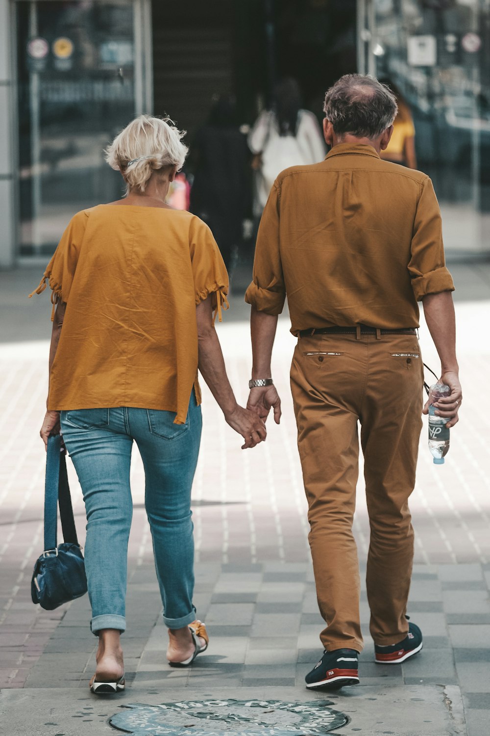 couple holding hands during daytime