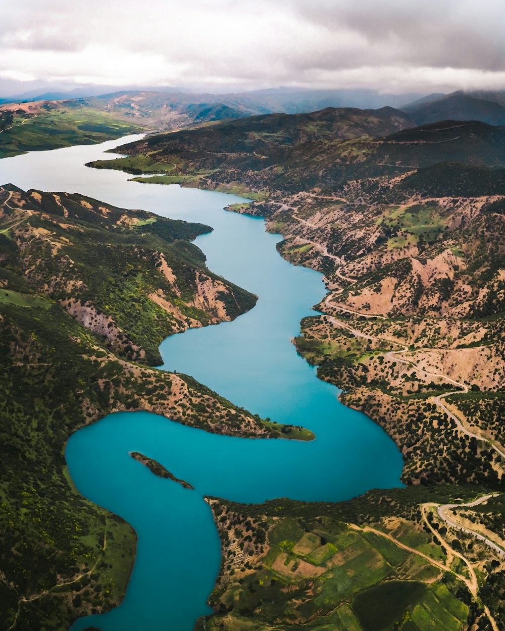 lake between green hills in aerial view
