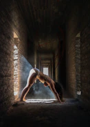 A serene yoga instructor demonstrating a precise Iyengar pose in a softly lit studio with warm beige walls.