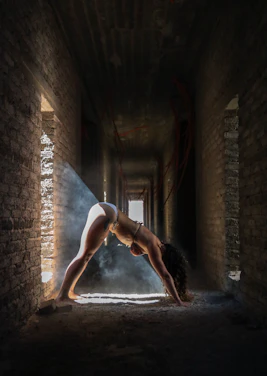 Portrait of Eugen Mîrtz in a serene yoga pose surrounded by warm natural light.