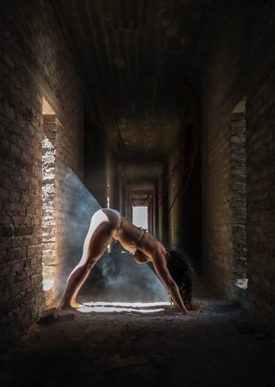 Portrait of Eugen Mîrtz in a serene yoga pose surrounded by warm natural light.