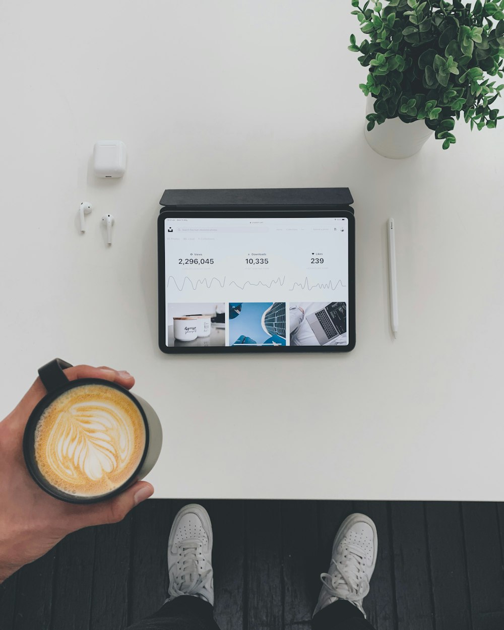 person holding mug with latte art