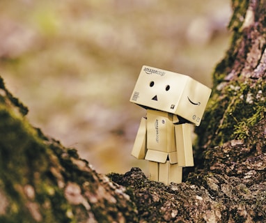 cardboard robot toy on wooden tree