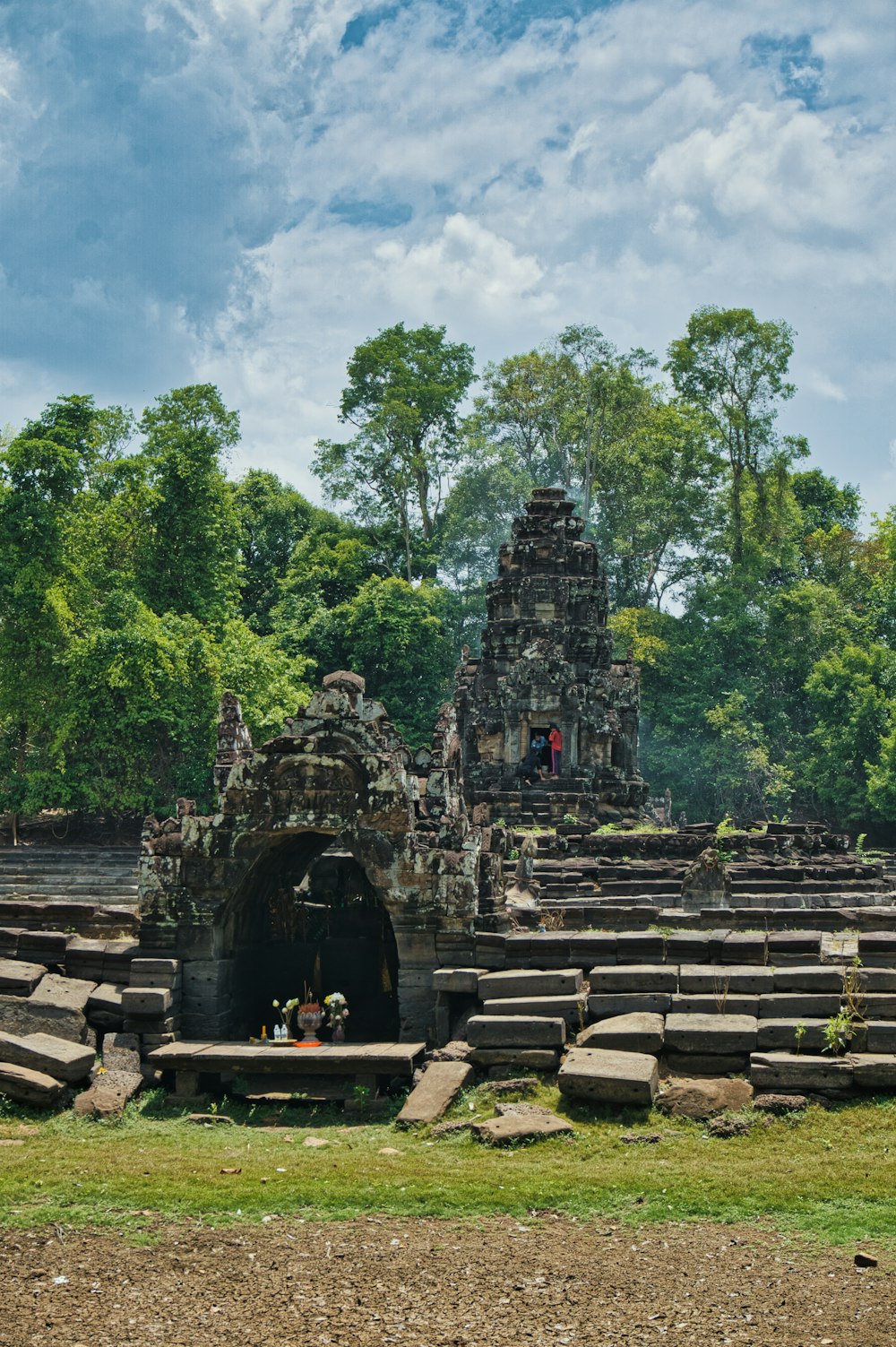 brick temple near green trees under white clouds