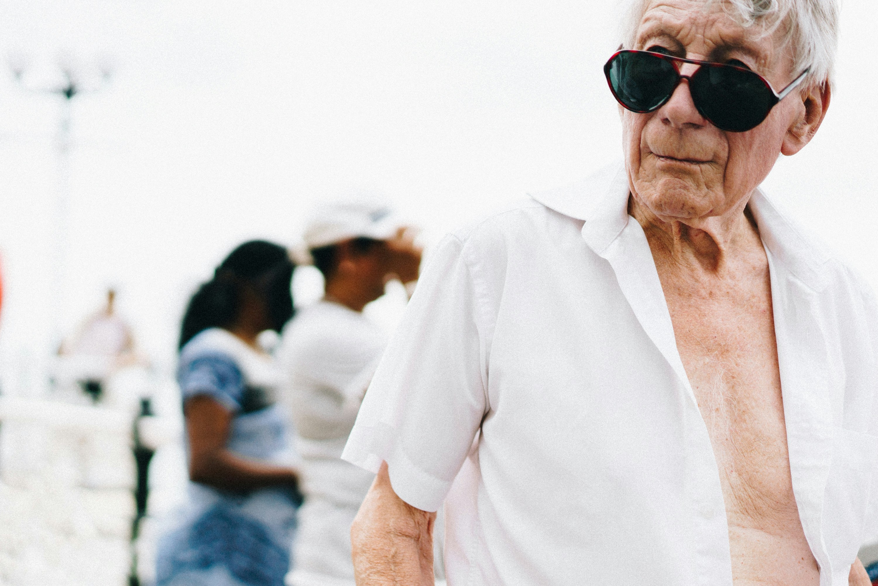 man standing in front of man and woman mature teams background