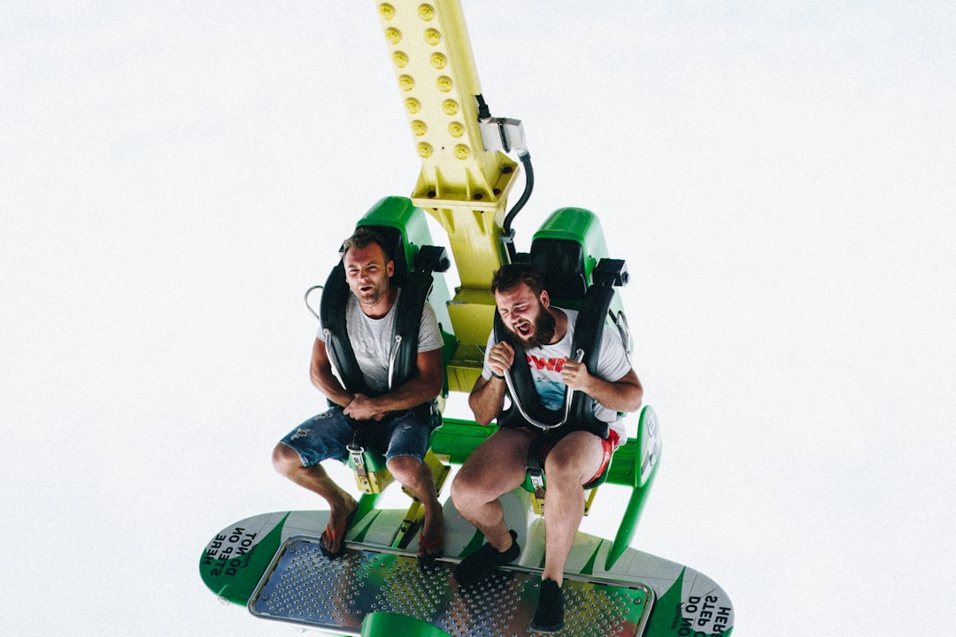 two men riding amusement ride