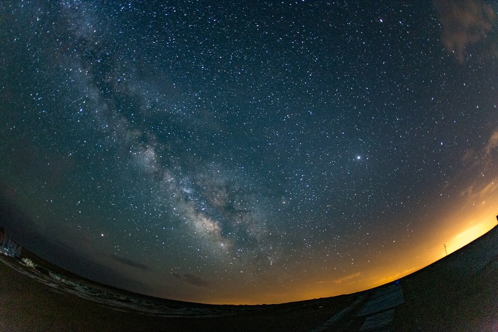 the night sky is filled with stars and clouds