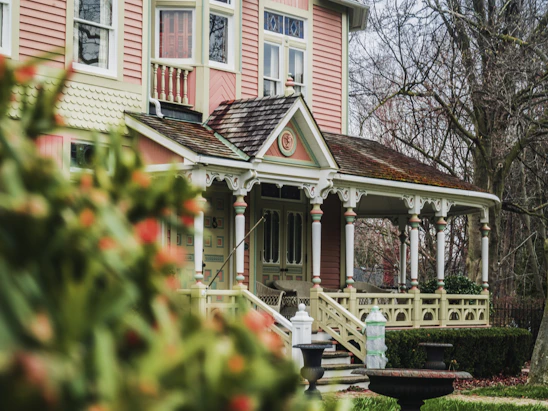 A warm portrait of the realtor standing in front of a charming historic home in St. Augustine.