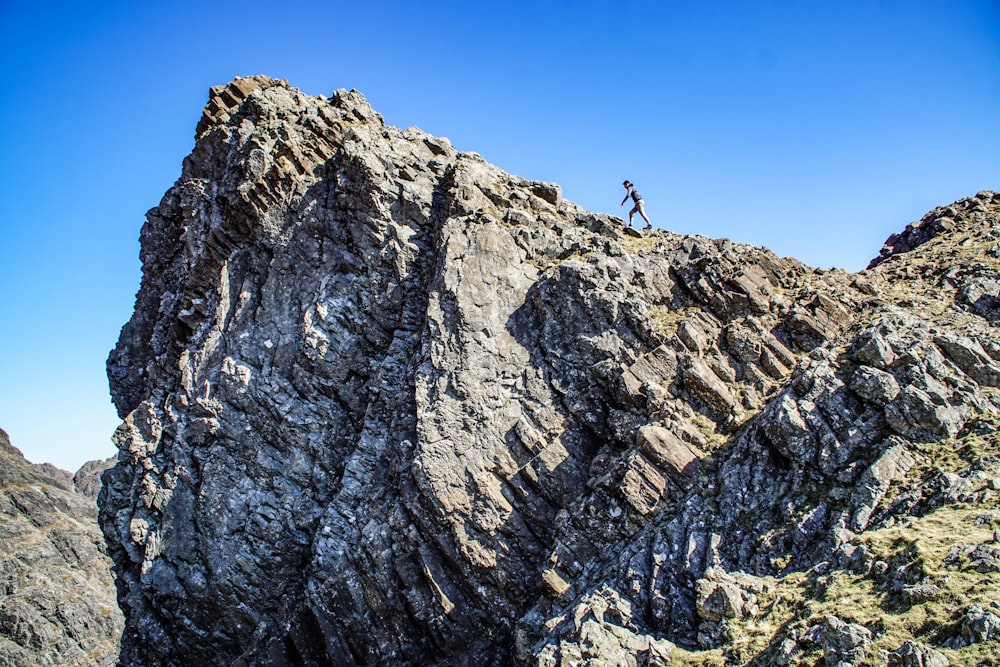 person waking on rocky mountain