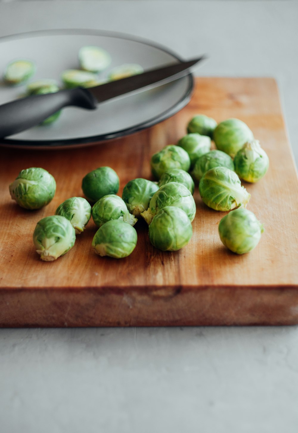 brussel sprouts on wooden chopping board and plate