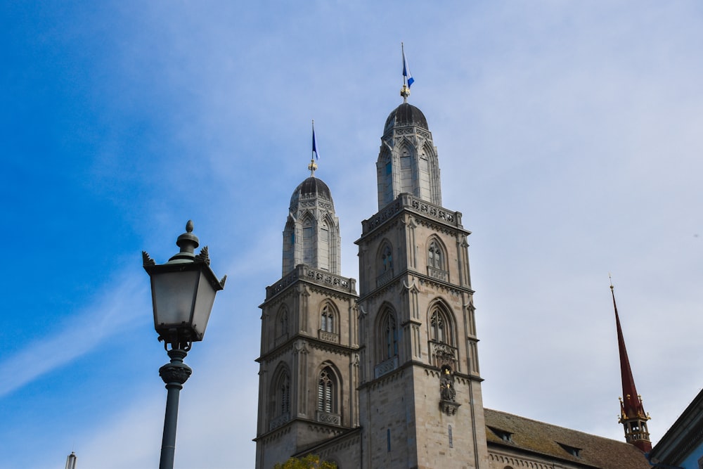 gray concrete towers and lamp posts under blue sky