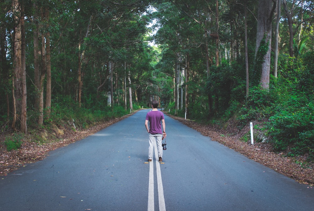 man standing on highway