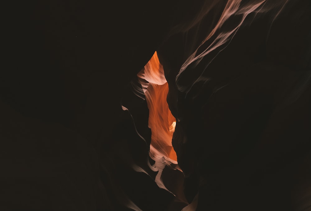 a narrow canyon with a red rock in the middle of it