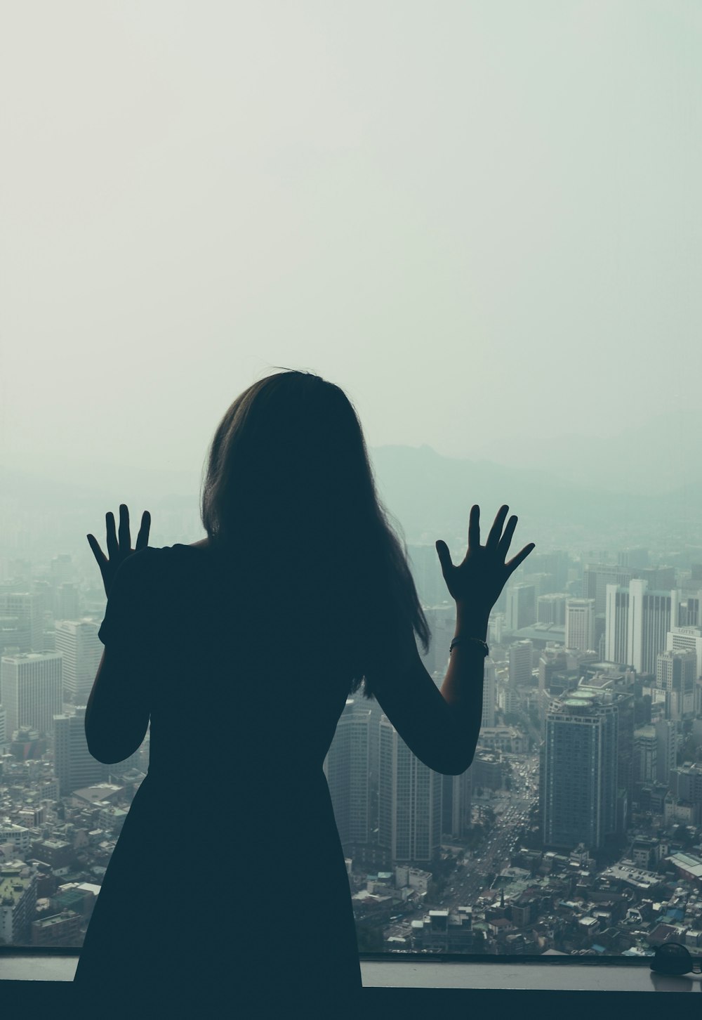 woman looking through window