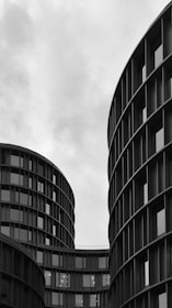 grayscale photo of high rise building with glass window