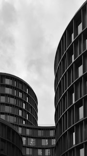 grayscale photo of high rise building with glass window
