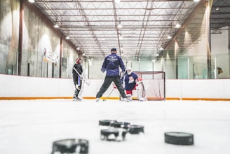 men playing ice hockey