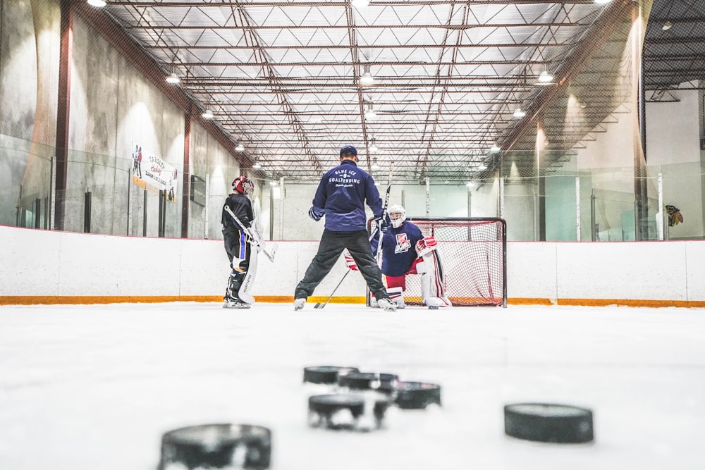 men playing ice hockey