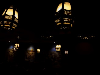 Luxurious Arabian-style lanterns glowing softly in a dimly lit, elegant setting.