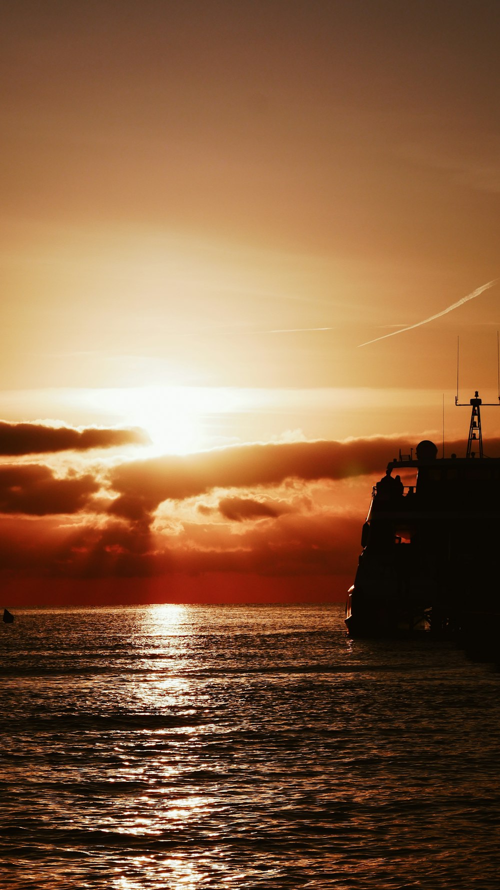 ship floating at the ocean during golden hour