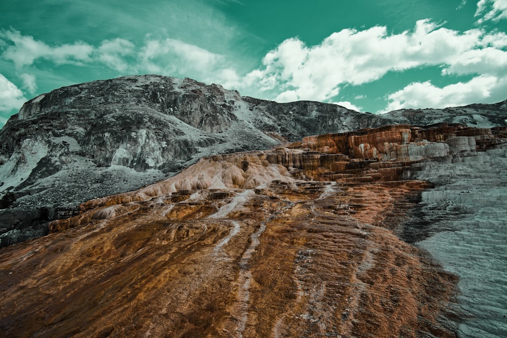 brown and grey mountain under white clouds