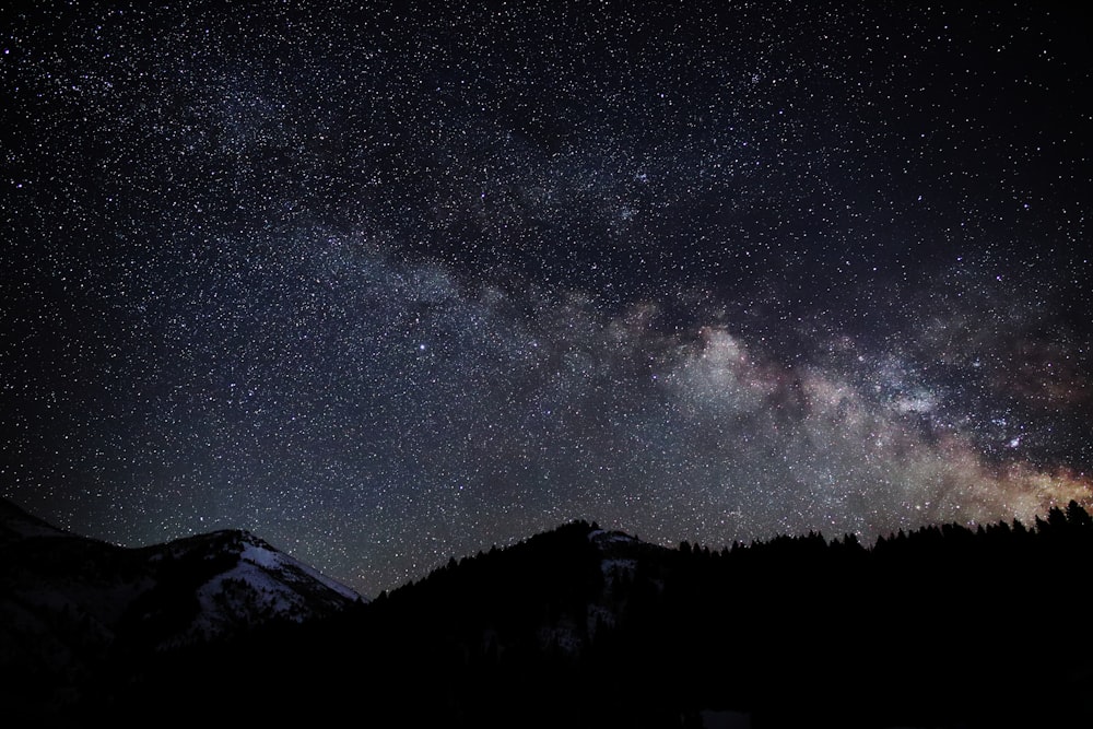 silhouette of mountain during starry night