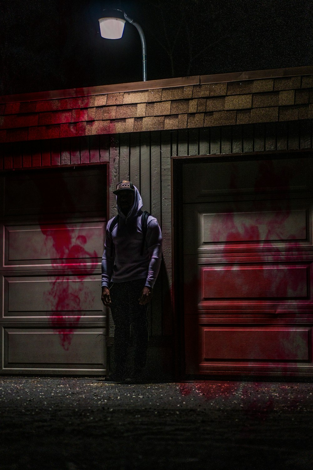 man standing next to building