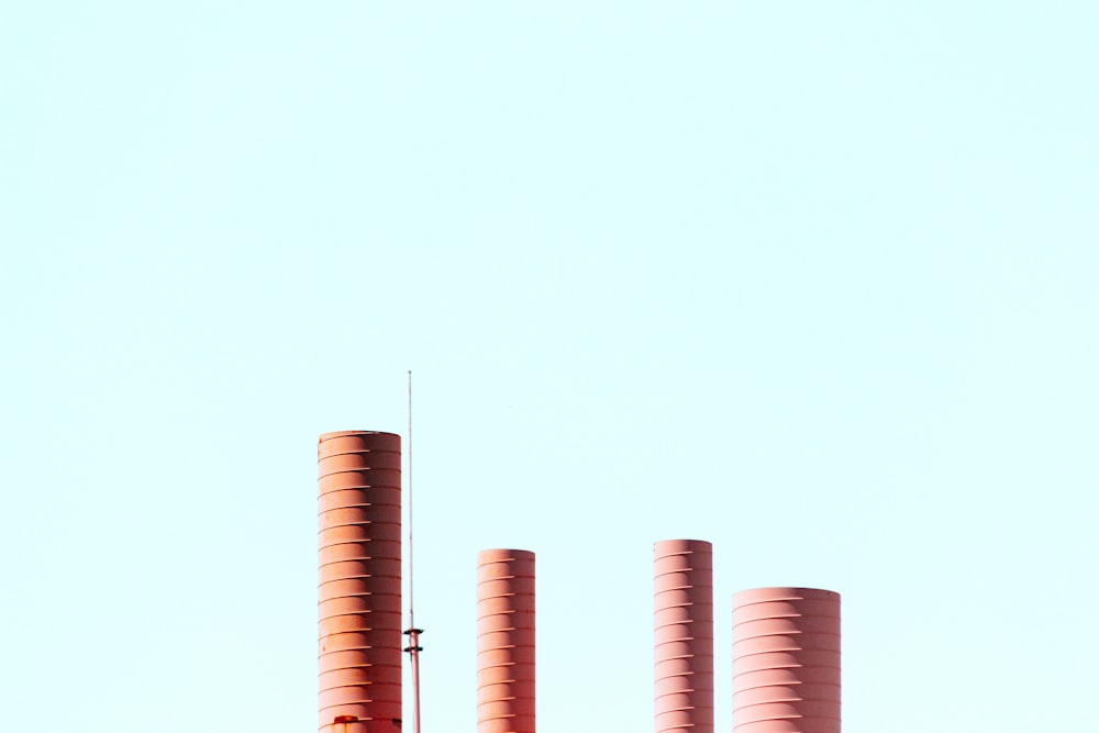 cylindrical brown tanks under blue sky