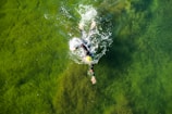 man swimming on water