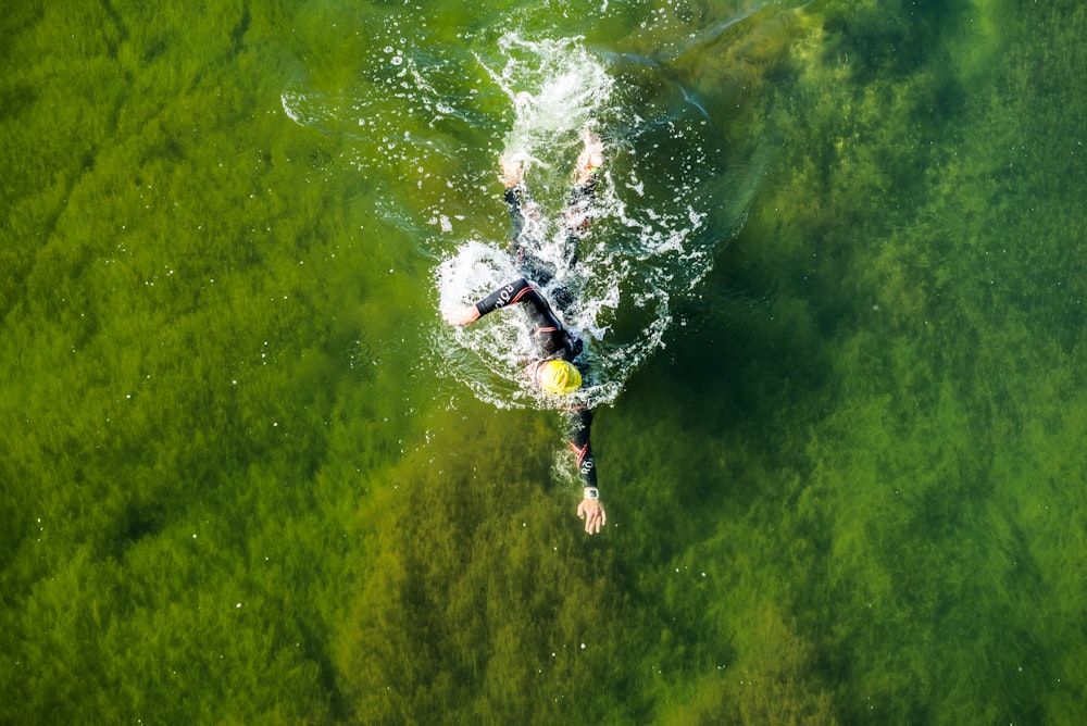 man swimming on water