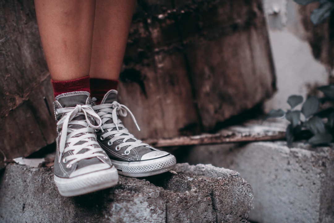 person wearing gray high top shoes