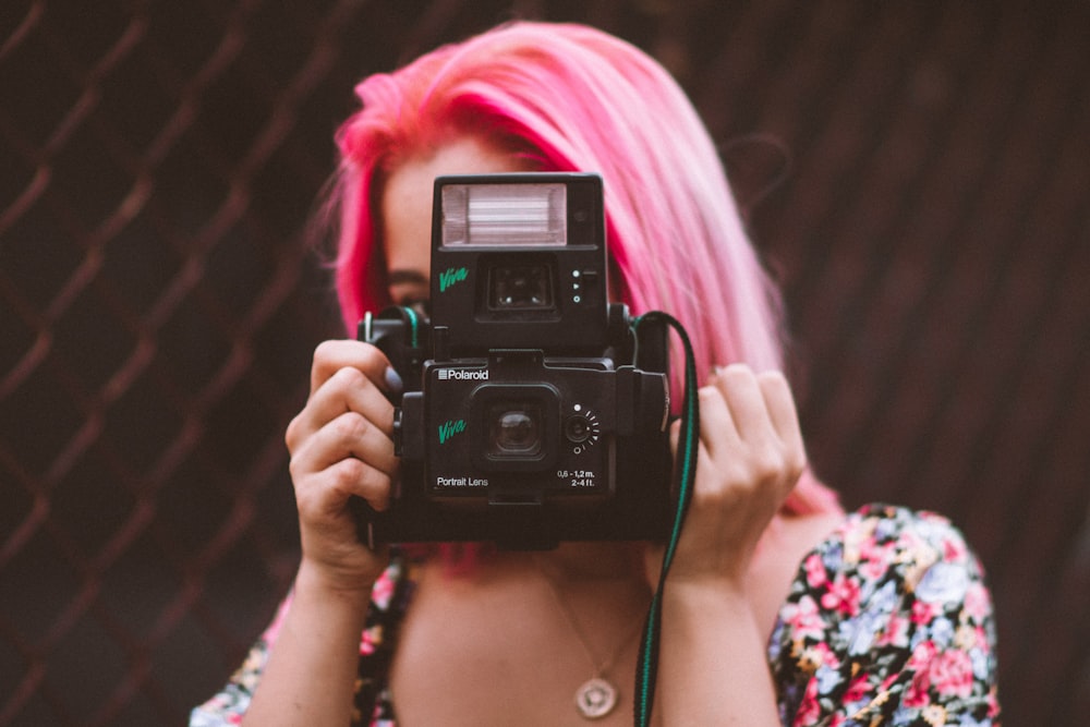 woman holding bridge camera