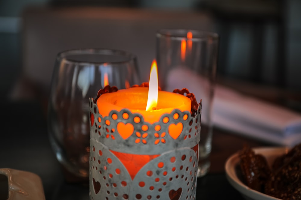 lighted tealight candle near wine glass