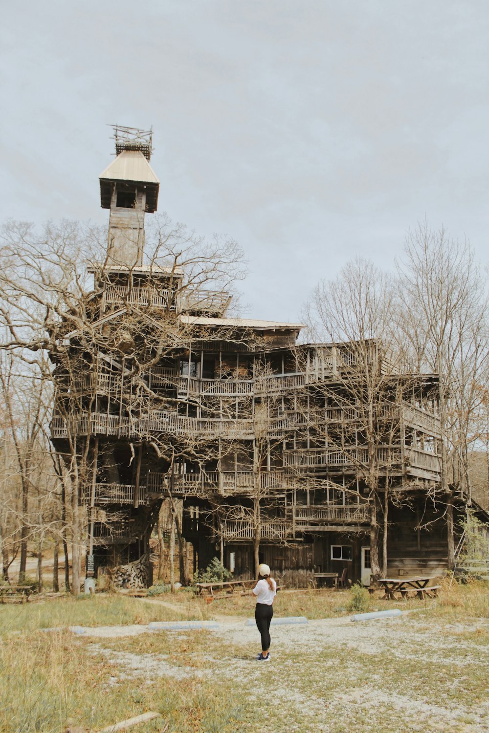 person standing near abandoned house during daytime