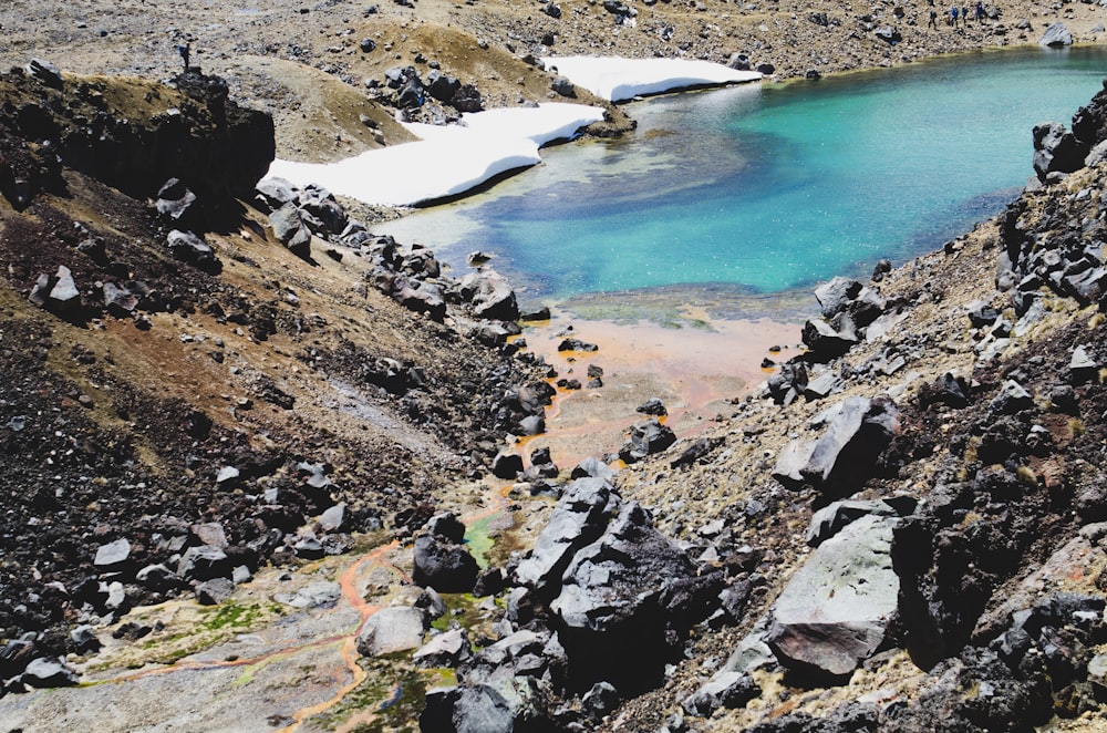 body of water between cliff