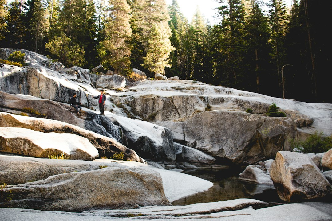 person standing on waterfalls,