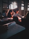 A group of students studying together in a well-lit common room.
