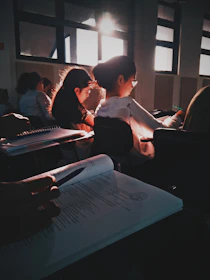 A group of diverse students studying together in a bright classroom.