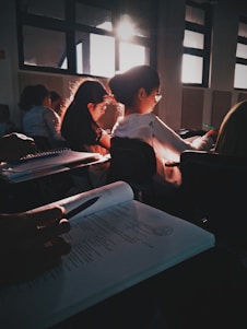 A diverse group of students collaborating on assignments in a bright study space.