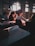 A smiling student studying math with a tutor in a bright, inviting classroom.