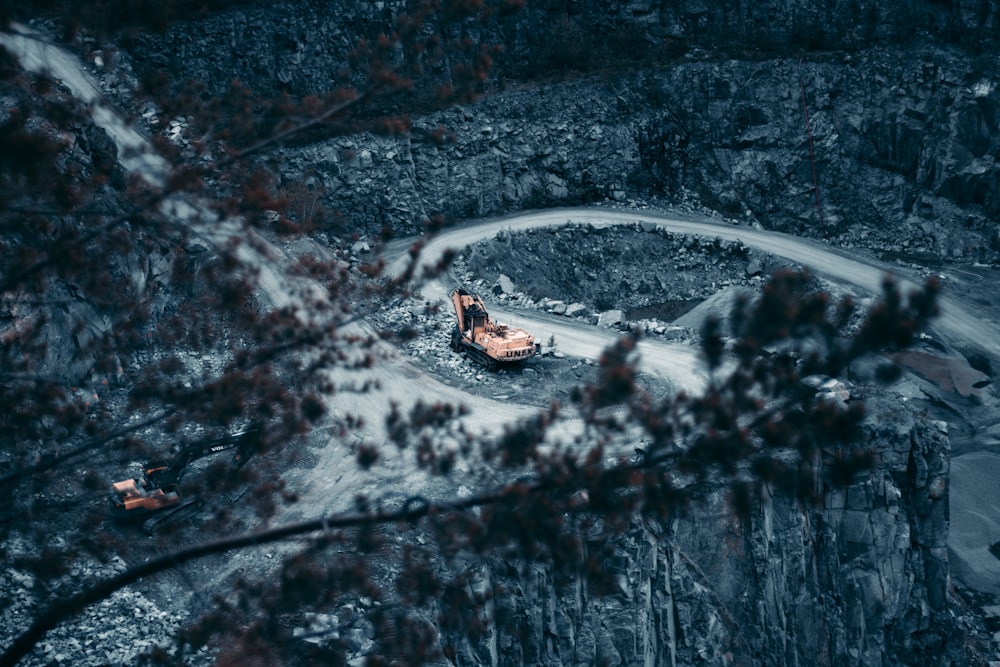 excavator on ground surrounded near body of water