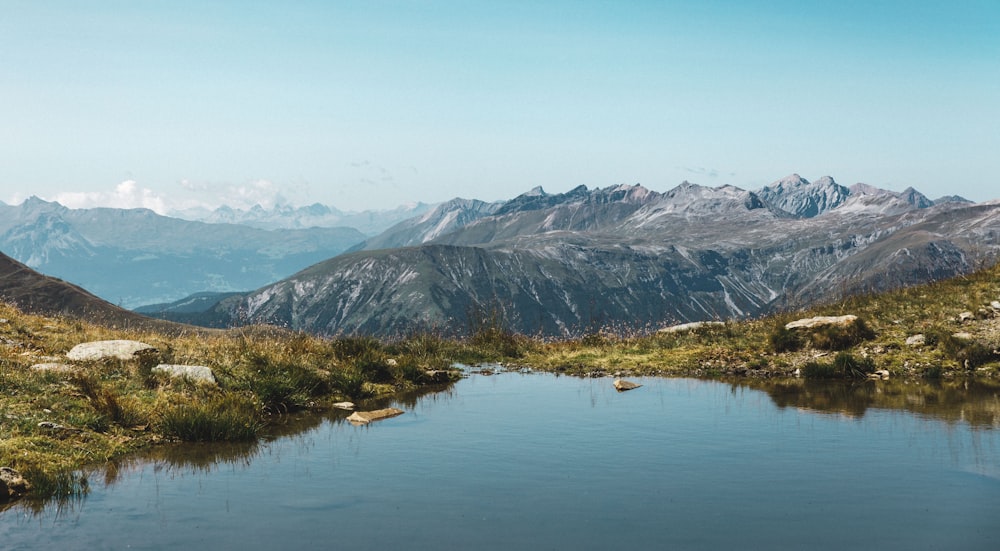 body of water and mountains during day