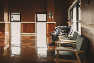 A minimalist coaching room with a simple chair, soft natural light, and calming decor.