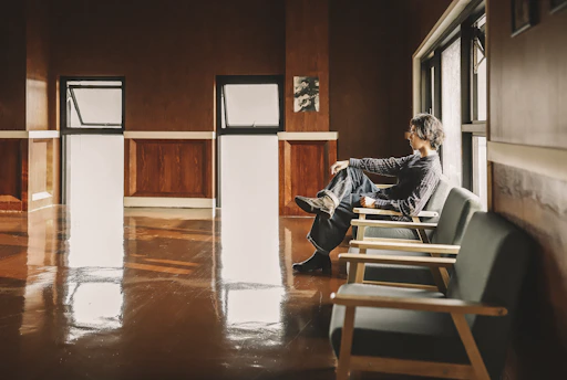 A calm, minimalist therapy room with a comfortable chair and soft natural light.