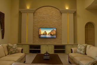 A cozy living room with a smart TV displaying a serene 4K oil painting of a countryside landscape.