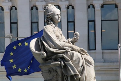 woman sitting statue in front of building real madrid google meet background