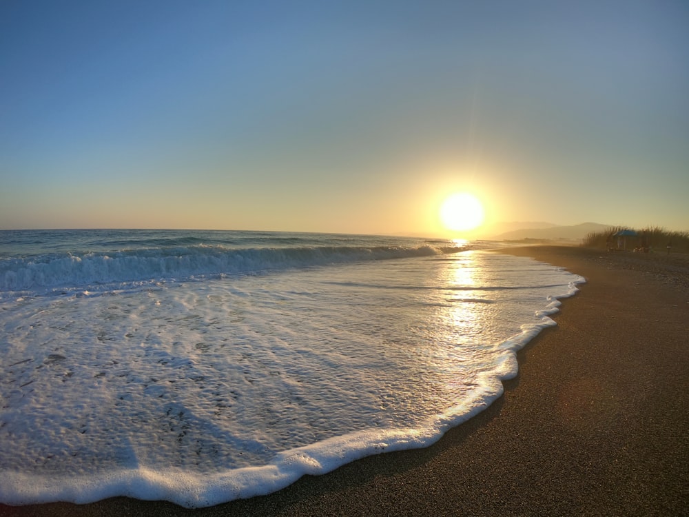 waves crashing on shore during golden hour