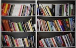 assorted books on a white shelf